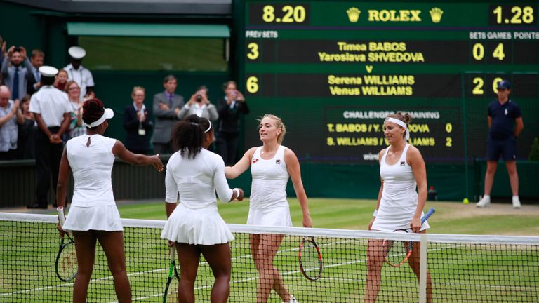 LONDON, ENGLAND - JULY 09:  Venus Williams of The United States and Serena Williams of The United States shake hands with Timea Babos of Hungary and Yarosl