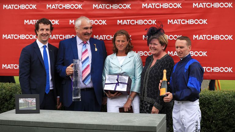 Winning owner George Materna (2nd left) with trainer Amanda Perrett (centre) and jockey Martin Dwyer (right) after You're Hired won at Goodwood