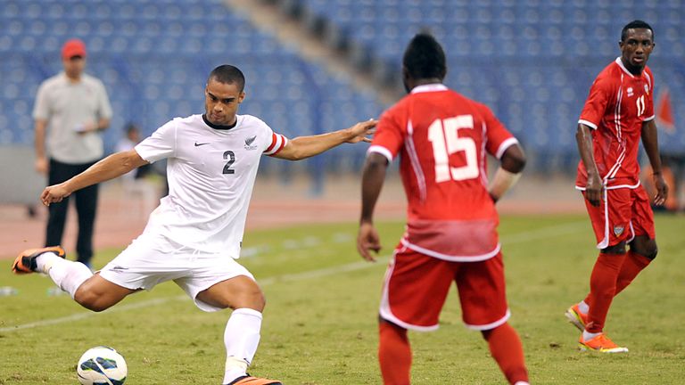 New Zealand's player Winston Reid (L) shoots the ball as UAE's national football team player Ismail Alhammadi (C) in 2013