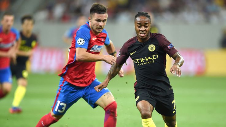 Raheem Sterling (R) vies for the ball with defender Alin Tosca