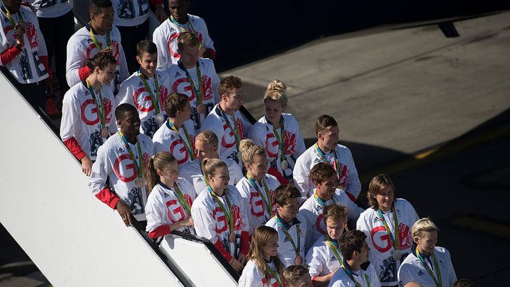 Team GB pose for photos upon arrival at Heathrow