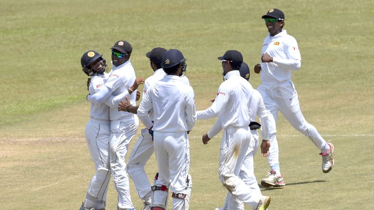 Sri Lanka's captain Angelo Mathews (2L) and cricketer Kusal Mendis (L) celebrate with teammates the wicket of Australian cricketer Peter Nevill during the 