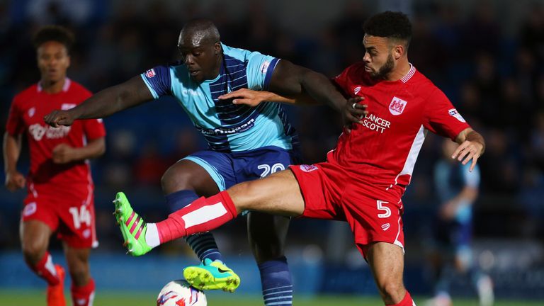 HIGH WYCOMBE, ENGLAND - AUGUST 08: Adebayo Akinfenwa of Wycombe Wanderers and Derrick Williams of Bristol City during the EFL Cup match between Wycombe Wan