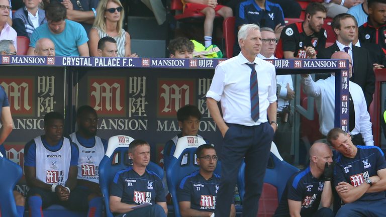 Crystal Palace's Wilfred Zaha sits on the bench behind his manager Alan Pardew 