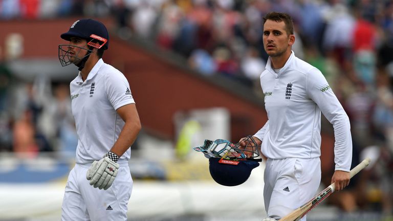 England's Alex Hales (R) and England's captain Alastair Cook leave at the end of play