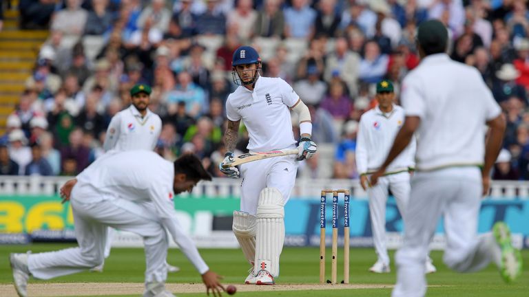 England's Alex Hales (3rd L) watches as Pakistan's Mohammad Amir (Below L) fields the ball during the first day of the third Test match at Edgbaston