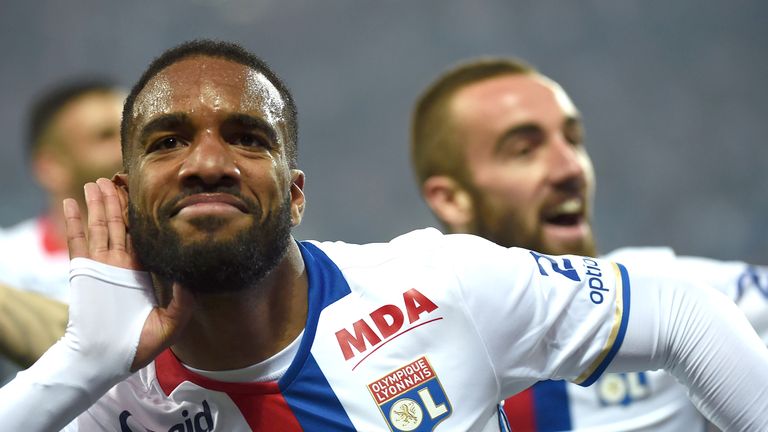 Alexandre Lacazette (C) celebrates after scoring for Ligue 1 side, Lyon