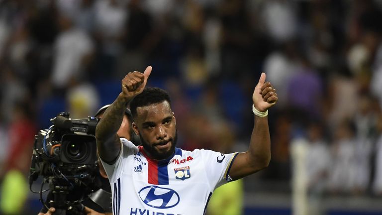 Lyon's French forward Alexandre Lacazette (L) gestures after scoring his second goal during the French Ligue 1 football match Olympique Lyonnais (OL) again