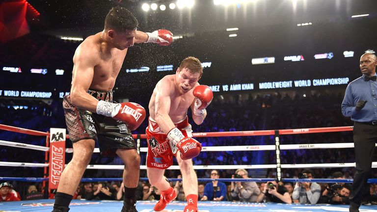 Canelo Alvarez (R) throws the knockout punch at Amir Khan during the WBC middleweight title fight at the T-Mobile Arena