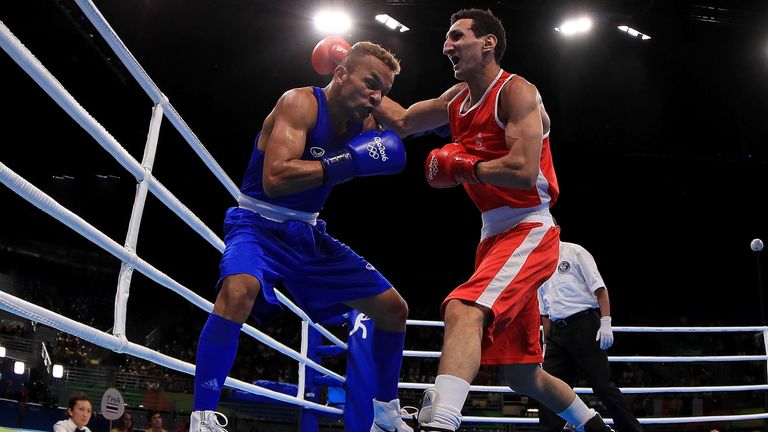 RIO DE JANEIRO, BRAZIL - AUGUST 09:  Sofiane Oumiha of France (Red) fights Amnat Ruenroeng of Thailand (Blue) in their Mens weight kg bout on Day 4 of the 