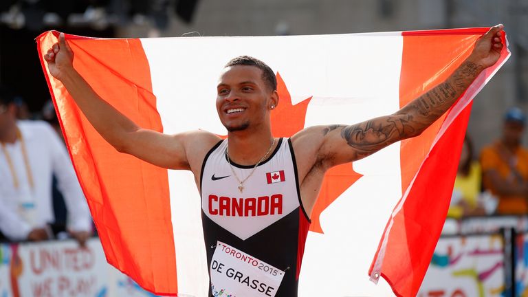 Andre De Grasse of Canada holds the Canadian flag after winning the men's 200 meter final on Day 14 of the Toronto 2015 Pan Am Game