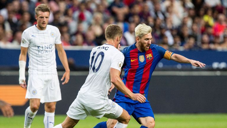 Leicester's Andy King (C) challenges Barcelona's Lionel Messi during the 2016 International Champions Cup friendly football match between FC Barcelona and 