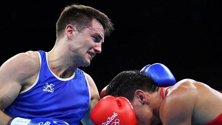Kazakhstan's Zhanibek Alimkhanuly (R) fights Great Britain's Antony Fowler 