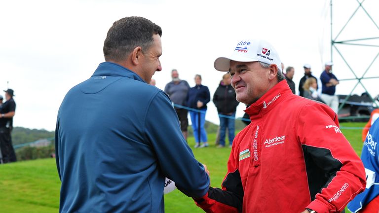 Wall is congratulated by tournament host Paul Lawrie after clinching victory at the last