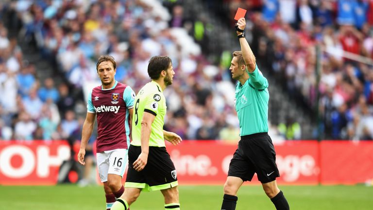 LONDON, ENGLAND - AUGUST 21:  Referee Craig Pawson shows the red card to Harry Arter of AFC Bournemouth during the Premier League match between West Ham Un