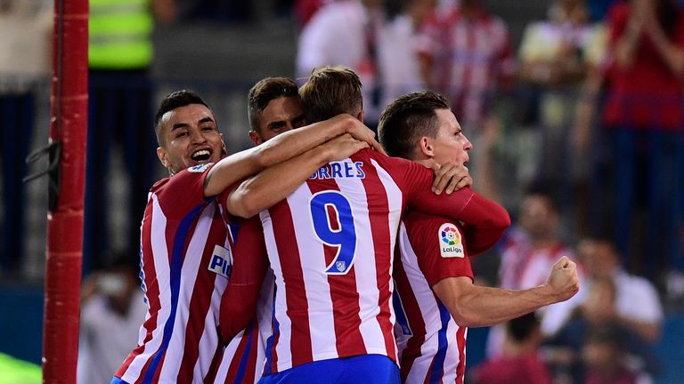 Atletico Madrid's French forward Kevin Gameiro (R) celebrates his goal during the Spanish league football match Club Atletico de Madrid vs Deportivo Alaves