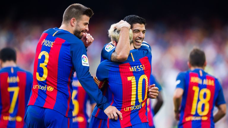 BARCELONA, SPAIN - AUGUST 20: Luis Suarez (R) of FC Barcelona celebrates with his teammates Lionel Messi (C) and Gerard Pique (L) after scoring his team's 