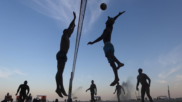 RIO DE JANEIRO, BRAZIL - JULY 24:  Brazilians play beach volleyball on Copacabana beach, near the Rio 2016 Olympic Games beach volleyball stadium, on July 