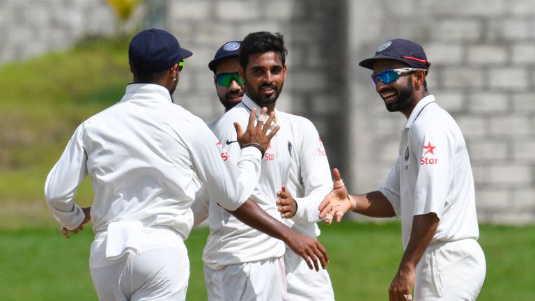 Bhuvneshwar Kumar (C) celebrates with Ajinkya Rahane (R) of India taking 5 West Indies wickets for 33 runs during day 4 of the 3rd Test between West Indies