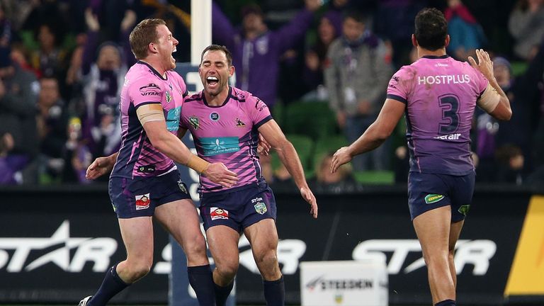 Cameron Smith of the Storm celebrates with team mates after kicking the golden point during the round 22 NRL match between Melbourne and South Sydney
