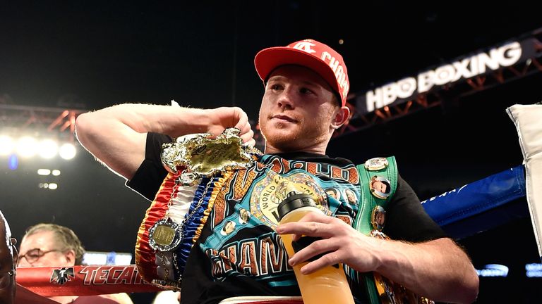 Canelo Alvarez stands with the WBC middleweight belt after defeating Amir Khan with a sixth-round knockout at a WBC middleweight title