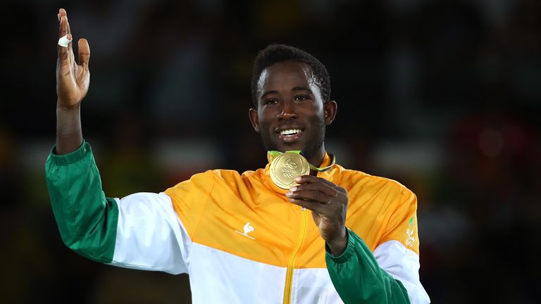 RIO DE JANEIRO, BRAZIL - AUGUST 19:  Gold medalist Cheick Sallah Cisse of Cote d'Ivoire poses on the podium during the medal ceremony for the Men's Taekwon