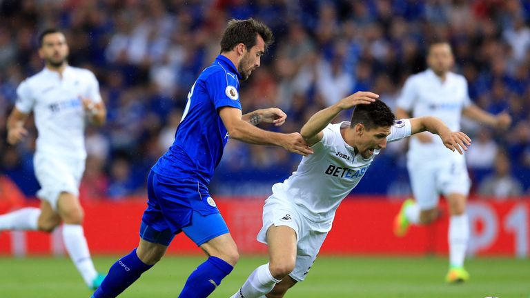 Leicester City's Christian Fuchs (left) and Swansea City's Federico Fernandez battle for the ball 