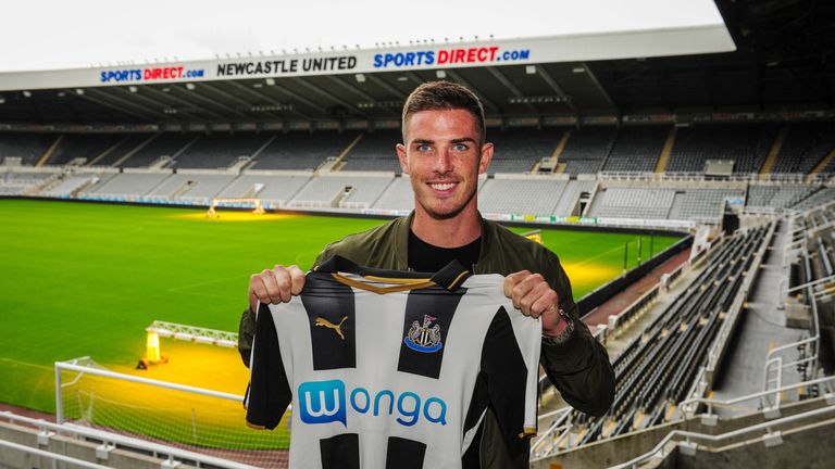 Ciaran Clark poses for a photograph with a home shirt