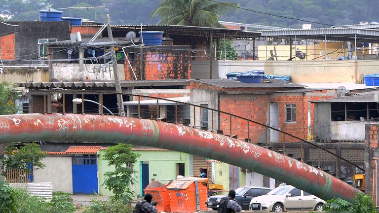 PM paramilitary police personnel man a checkpoint on a bridge in the Cidade de Deus shantytown, 10km from the Olympic Village Rio de Janeiro, Brazil on Jul