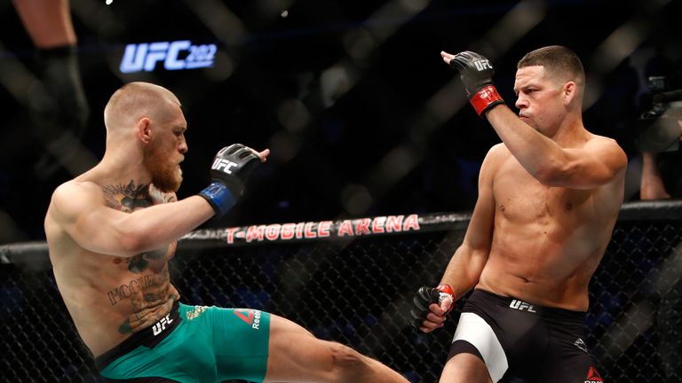 LAS VEGAS, NV - AUGUST 20:  Conor McGregor (L) kicks Nate Diaz during their welterweight rematch at the UFC 202 event at T-Mobile Arena on August 20, 2016 