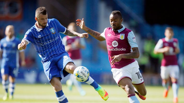Sheffield Wednesday's Daniel Pudil and Aston Villa's Jordan Ayew battle for the ball .