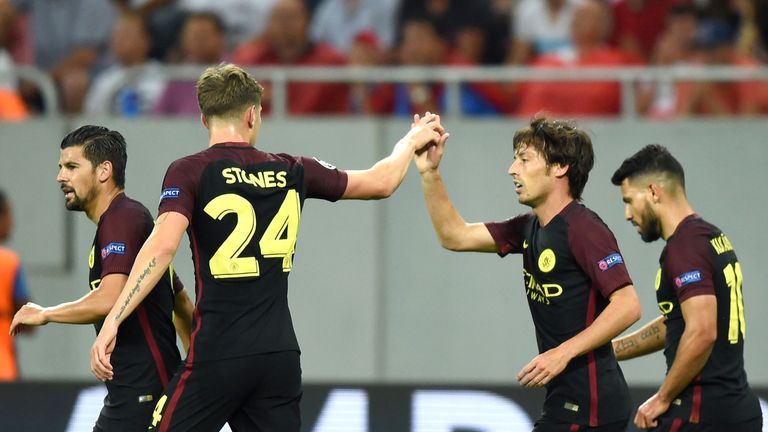 David Silva (2R) celebrates scoring the opening goal of the game