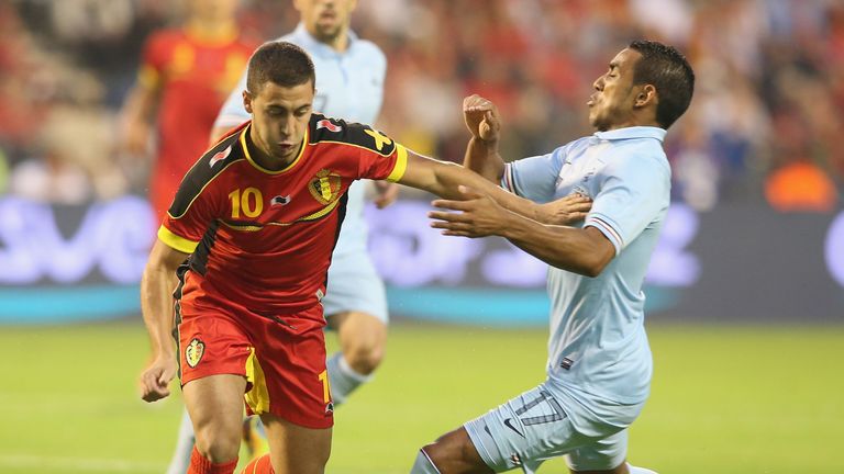 Eden Hazard moves away from Dimitri Payet during the international friendly match between Belgium and France in Brussels in August 2013