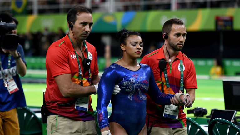 Ellie Downie leaves the gymnastics arena in Rio after hurting her neck on Sunday