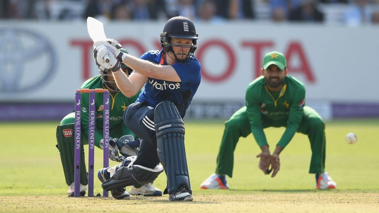 Eoin Morgan reverse sweeps on his way to a long-awaited half-century