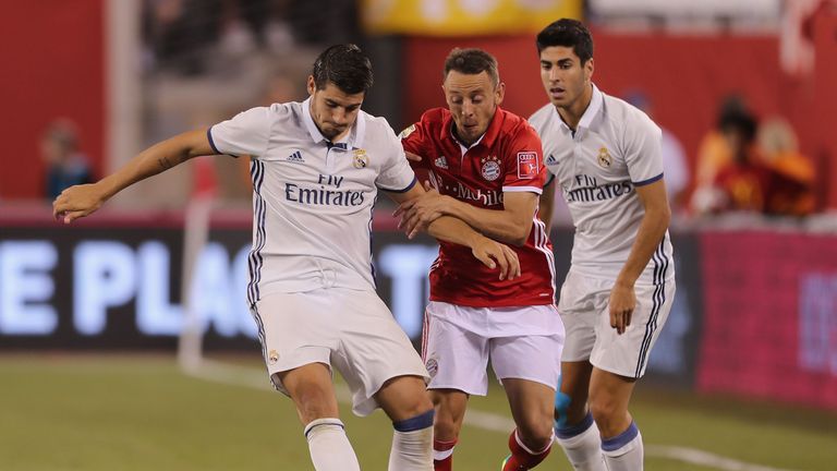 Alvaro Morata (left) tussles for the ball