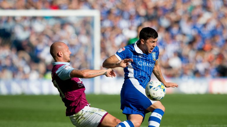 SHEFFIELD, ENGLAND - AUGUST 07: Alan Hutton of Aston Villa is challenged by Fernando Forestieri of Sheffield Wednesday during the Sky Bet Championship matc