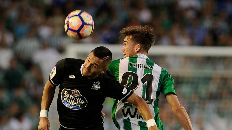 Deportivo La Coruna's midfielder Florin Andone (L) vies with Betis' midfielder Fabian during the Spanish league football match Real Betis Balompie versus D