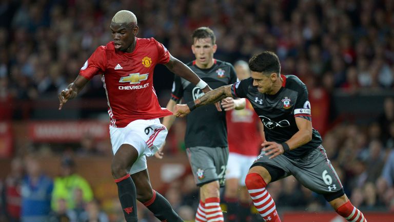 Paul Pogba (L) vies for possession with Jose Fonte (R)