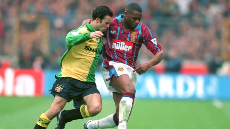 Aston Villa's Dalian Atkinson holds off Manchester United's Ryan Giggs