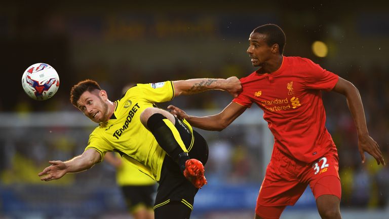 BURTON UPON TRENT, ENGLAND - AUGUST 23:  Calum Butcher of Burton Albion is challenged by Joel Matip of Liverpool during the EFL Cup second round match betw