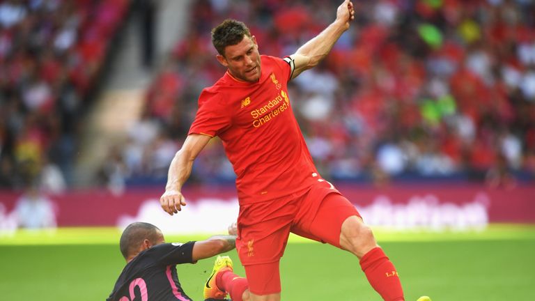 James Milner of Liverpool is tackled by Barcelona's Aleix Vidal