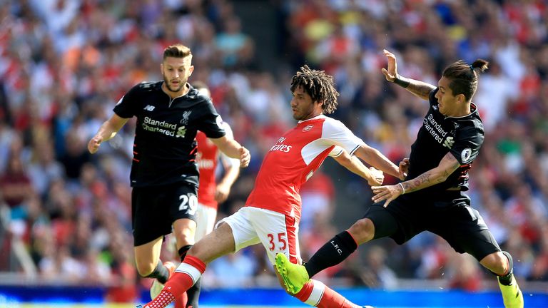 Arsenal's Mohamed Elneny (centre) battles for the ball with Liverpool's Roberto Firmino (right) 