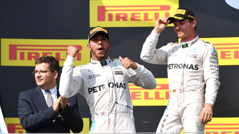 Lewis Hamilton (C) celebrates in front of  Mercedes team-mate Nico Rosberg