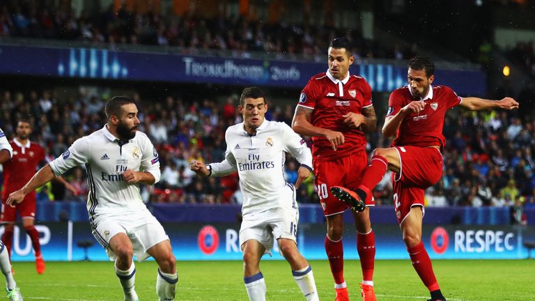 Franco Vazquez (R) of Sevilla scores his team's opening goal during the UEFA Super Cup match between Real Madrid and Sevilla
