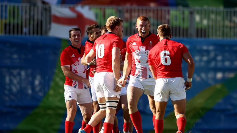 RIO DE JANEIRO, BRAZIL - AUGUST 11:  Great Britain players celebrate victory after the Men's Rugby Sevens semi final match between Great Britain and South 