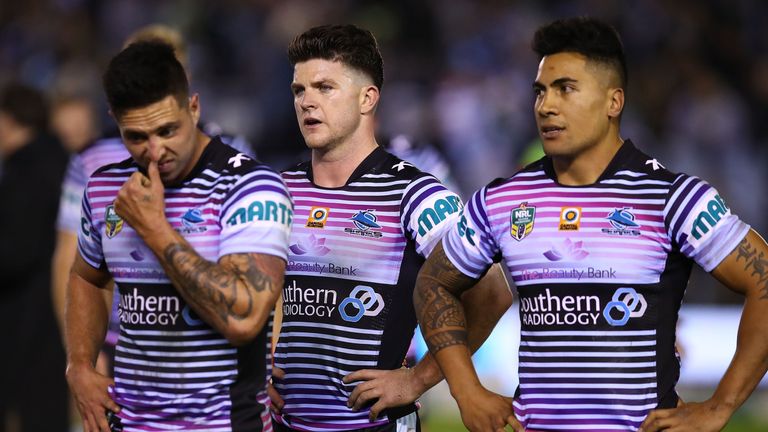 Gerard Beale, Chad Townsend and Sosaia Feki of the Sharks show their dejection at full time following the round 22 NRL loss