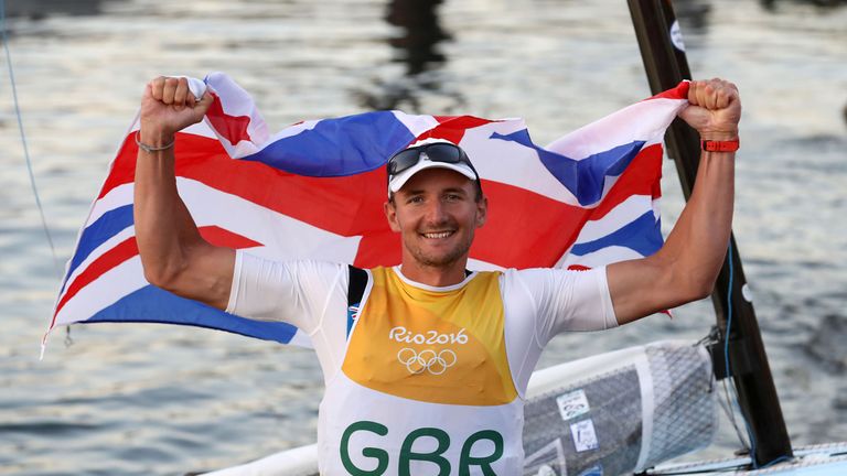 Giles Scott poses with a flag at the Maria da Gloria