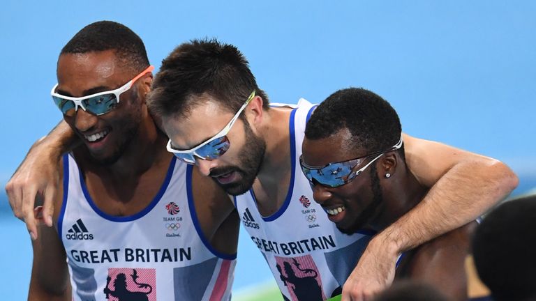 Britain's Matthew Hudson-Smith (L), Britain's Martyn Rooney (C) and Britain's Nigel Levine react after competing in the Men's 4x400m Relay Round 1 during t