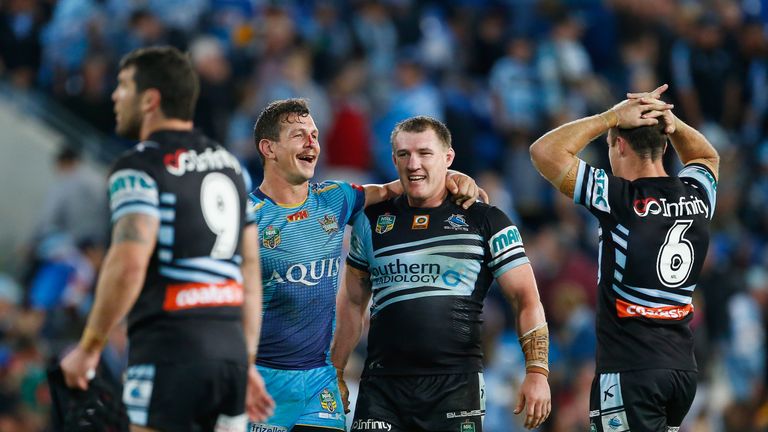 Greg Bird of the Titans and  Paul Gallen of the Sharks embrace after an 18 all draw during the round 21 NRL match